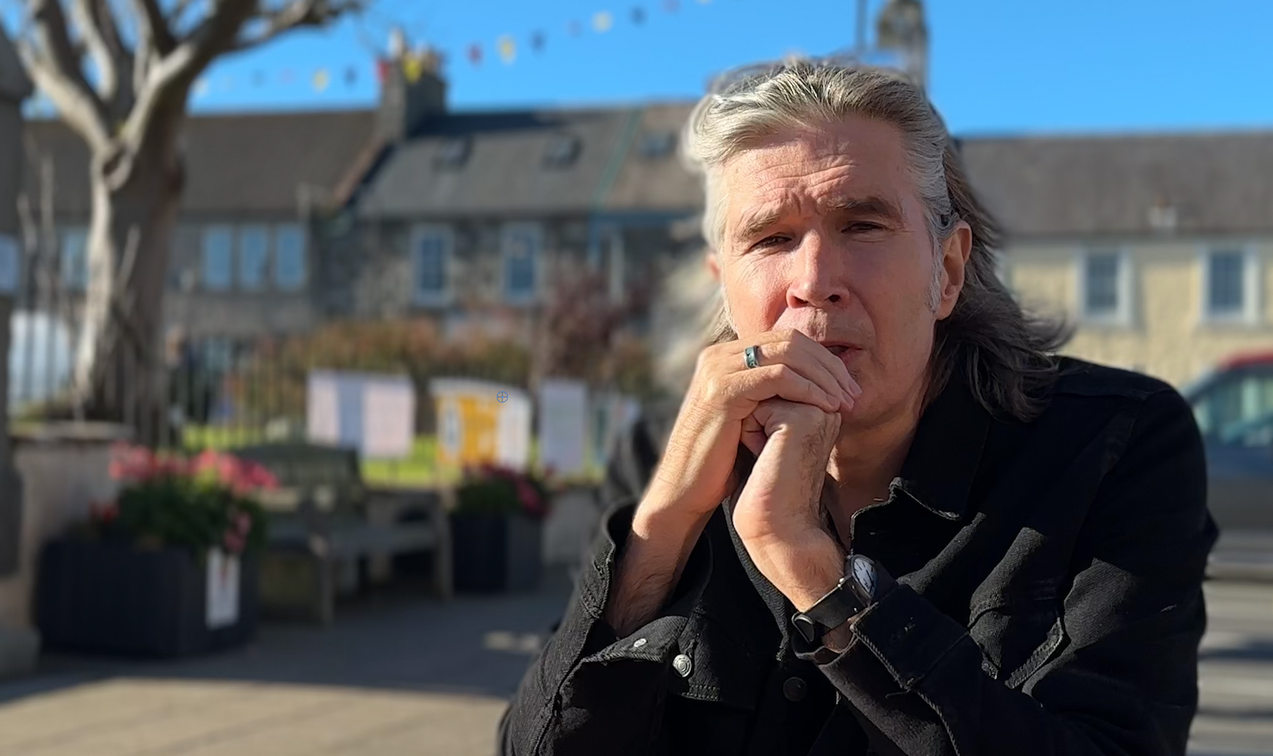 Justin Currie, singer and songwriter, frontman of Del Amitri, sitting outside at Wigtown Book Festival